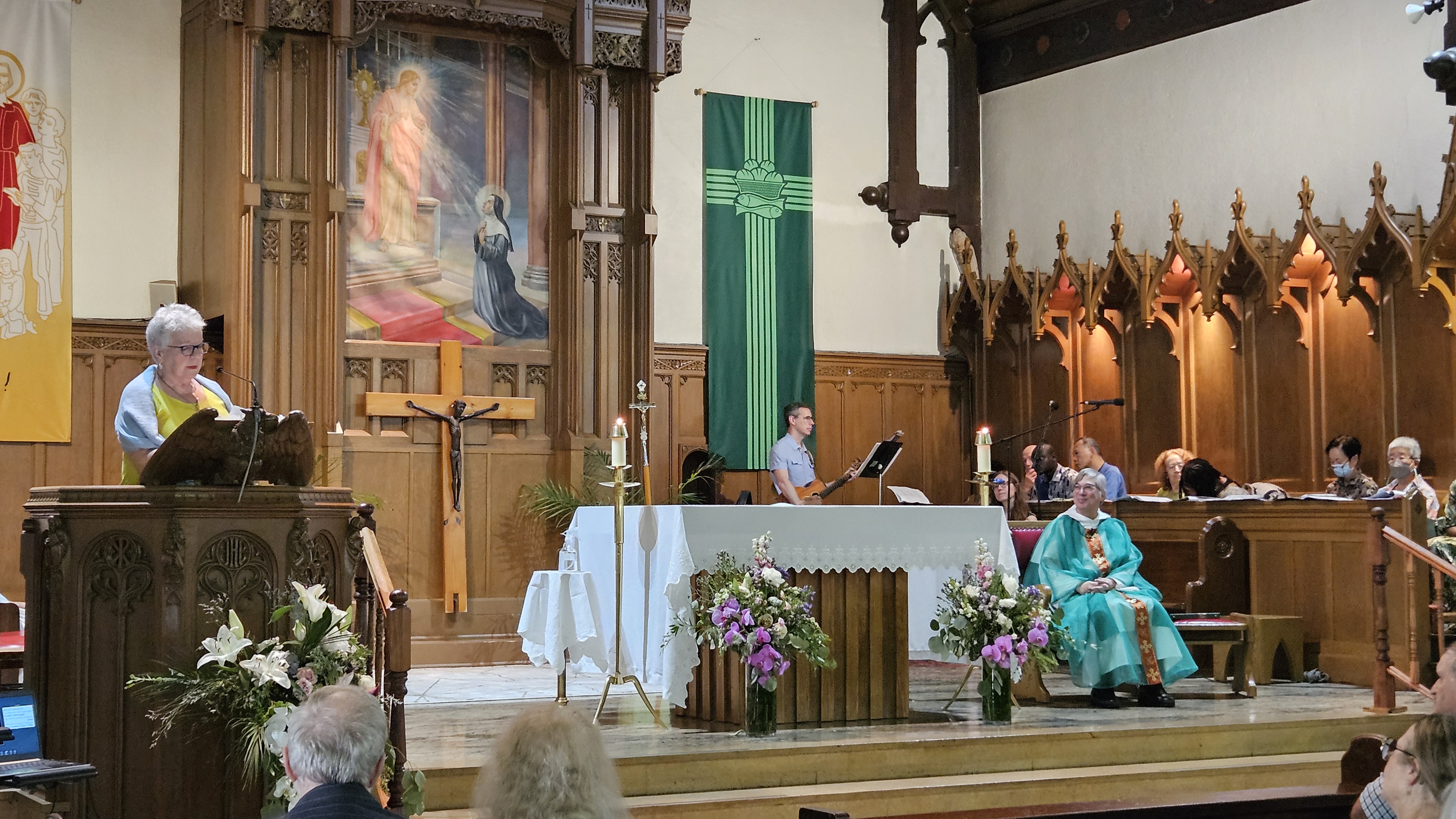 A woman speaking from the pulpit of a church