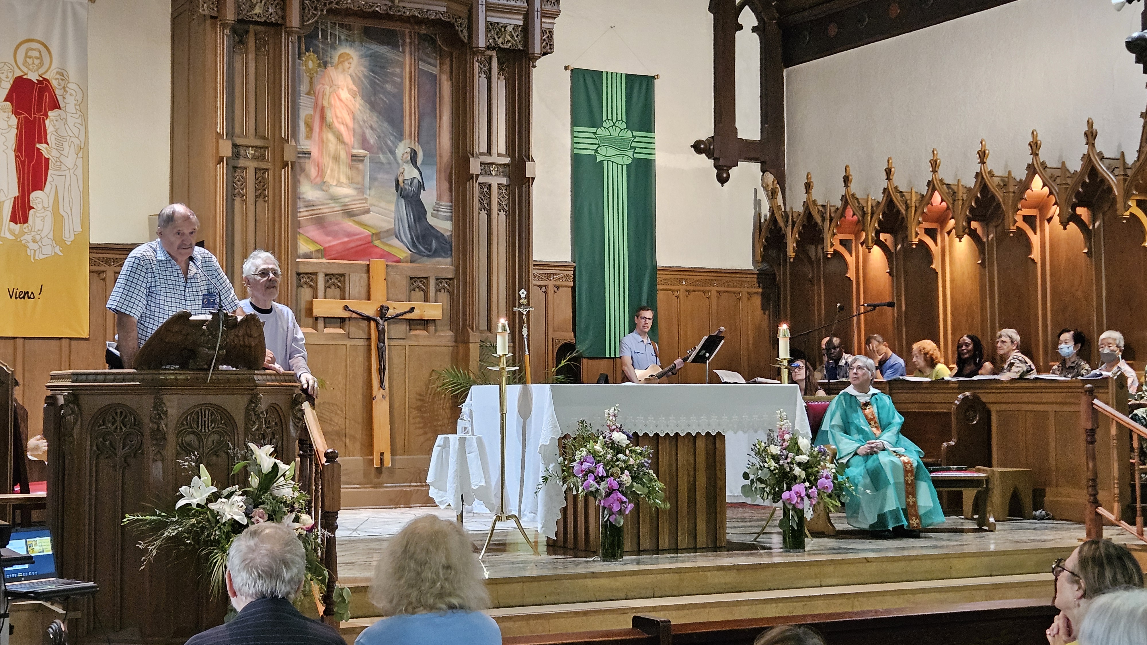 A man speaking from the pulpit of a church