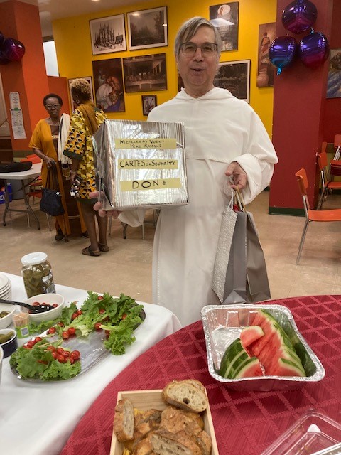 A man in religious garb holding a box